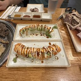 a large platter of meats and sushies a large platter of meats and sushies