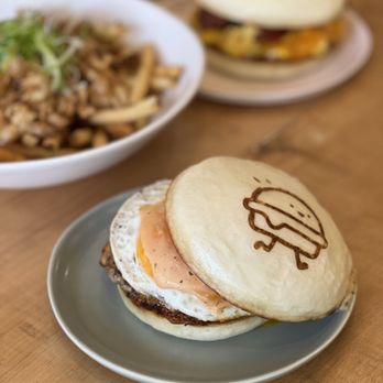 Petite Bao - a plate of food on a table - Burgers Near Me - Vancouver, British Columbia