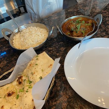 Naan Stop Indian Cuisine - Goat Masala with Bone, rice and garlic naan - Indian Near Me - Durham, North Carolina Naan Stop Indian Cuisine - Goat Masala with Bone, rice and garlic naan - Indian Near Me - Durham, North Carolina