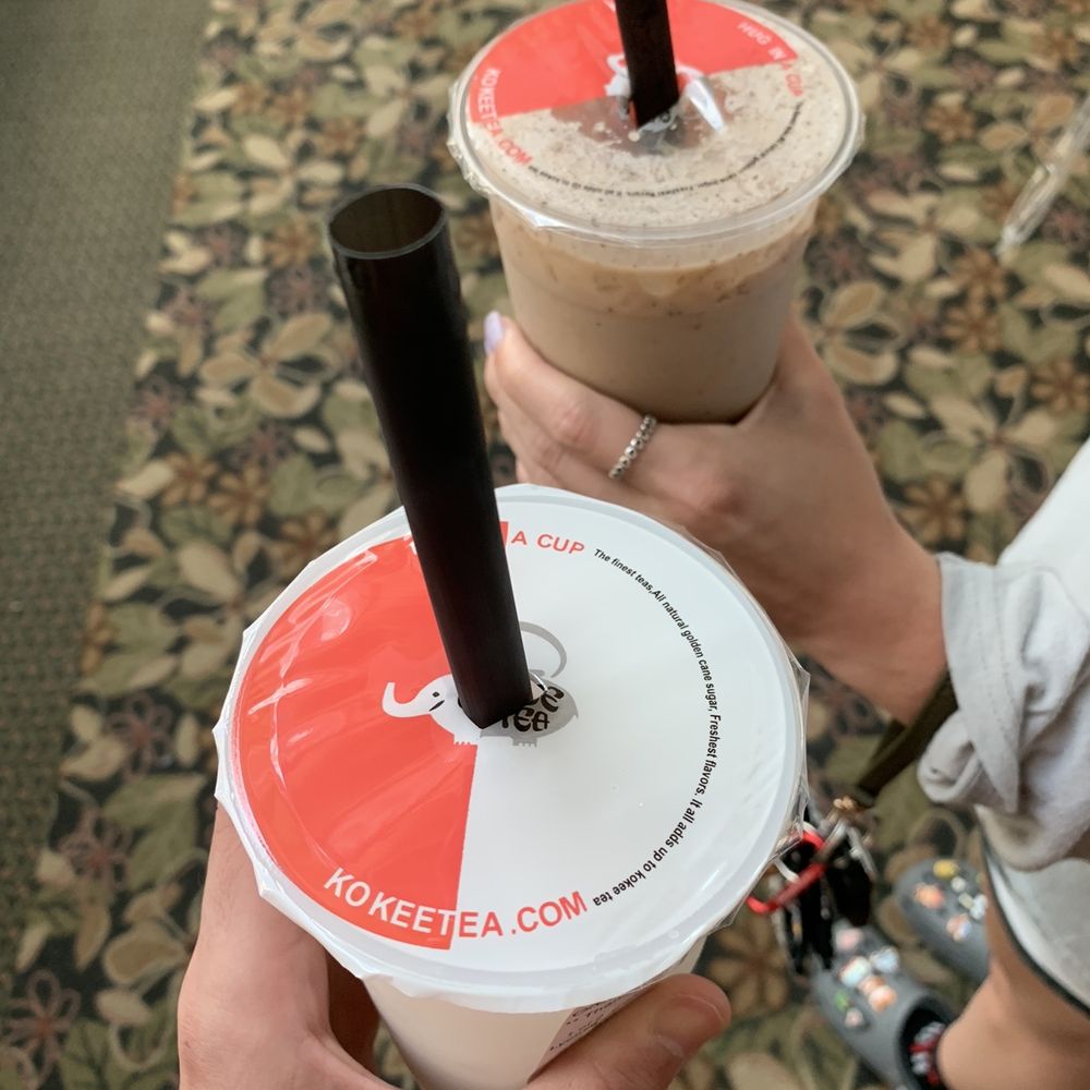 a person holding two cups of coffee