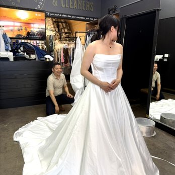 Custom Cuts Tailoring & Cleaners - Bride during a wedding dress fitting and alterations with our master tailor at Custom Cuts Tailoring & Cleaners in Fullerton. - Sewing & Alterations Near Me - Fullerton, California Custom Cuts Tailoring & Cleaners - Bride during a wedding dress fitting and alterations with our master tailor at Custom Cuts Tailoring & Cleaners in Fullerton. - Sewing & Alterations Near Me - Fullerton, California