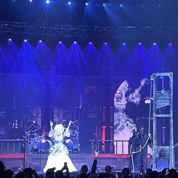 Hershey Theatre - A stage show featuring performers in costumes, with dramatic lighting and background screens displaying images, at a theater or concert venue. - Performing Arts Near Me - Hershey, Pennsylvania