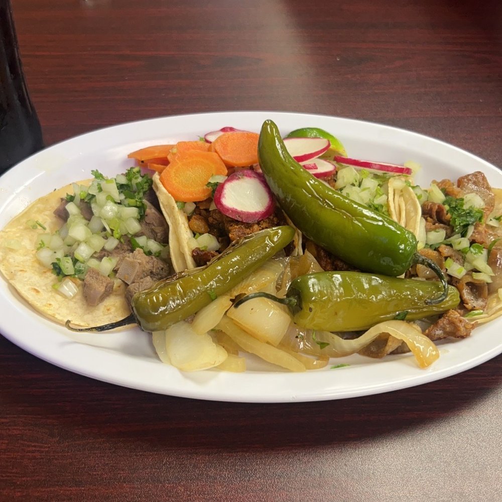 Street tacos; 2 Al pastor, lengua and tripa.