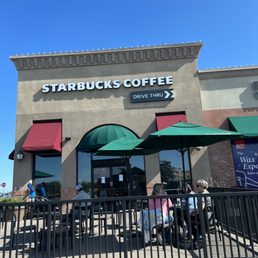 people sitting at tables outside