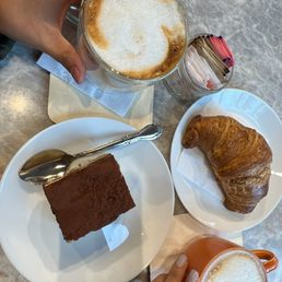 Tiramisu, croissant, cappuccino and latte Tiramisu, croissant, cappuccino and latte