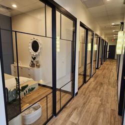 Blessed Lashes and Beauty - Our beautiful hallway, lined with custom sliding glass doors on one side and crystal wall sconces and gorgeous black wood doors on the other