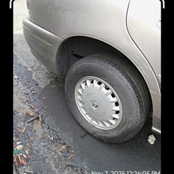 PChange Protective Services - Tire that security claimed was flat. It's still attached to the tow truck and hadn't even been put in the yard yet
