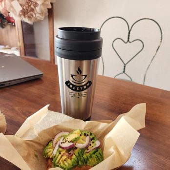 Isleton Coffee Company - Isleton Coffee Company's signature tumbler filled with Raven's Brew, next to their delicious avocado toast. - Coffee & Tea Near Me - Isleton, California Isleton Coffee Company - Isleton Coffee Company's signature tumbler filled with Raven's Brew, next to their delicious avocado toast. - Coffee & Tea Near Me - Isleton, California