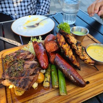 Limón - Steak, sausage and skewers on potatoes and asparagus - Peruvian Near Me - Oakland, California Limón - Steak, sausage and skewers on potatoes and asparagus - Peruvian Near Me - Oakland, California