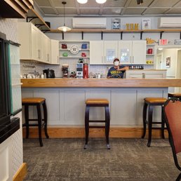 a counter with stools in front of it a counter with stools in front of it