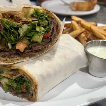 Zizi's Cafe - Zizi's Favorite Doner Wrap. Thin dough topped with seasoned ground beef and mozzarella cheese, Doner (A homemade Gyro) - Mediterranean Near Me - Chicago, Illinois Zizi's Cafe - Zizi's Favorite Doner Wrap. Thin dough topped with seasoned ground beef and mozzarella cheese, Doner (A homemade Gyro) - Mediterranean Near Me - Chicago, Illinois