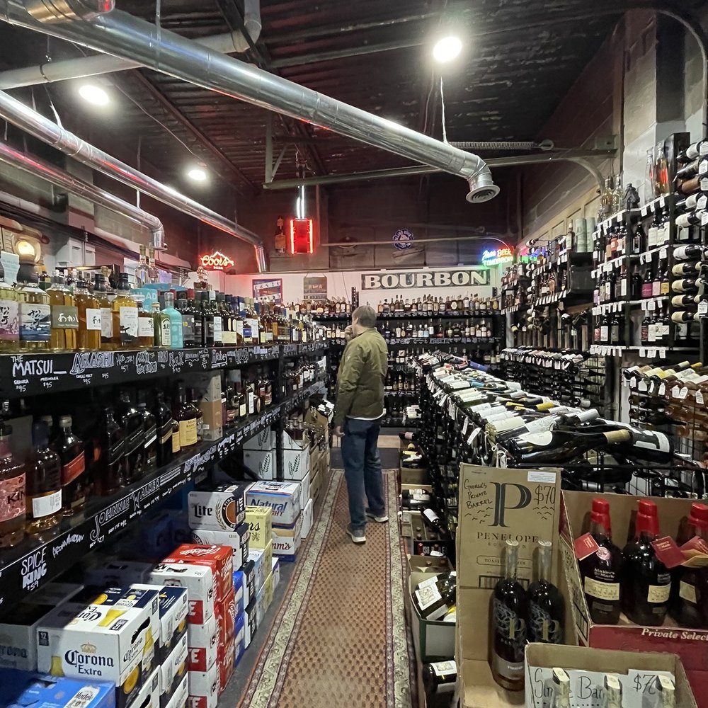 a man shopping in a liquor store a man shopping in a liquor store