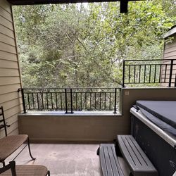 Balcony/private patio with hot tub.