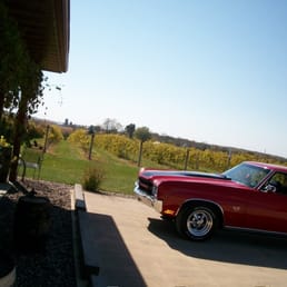 a classic car parked in a driveway a classic car parked in a driveway