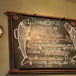 Sushi Okalani - A sign on the wall with specials