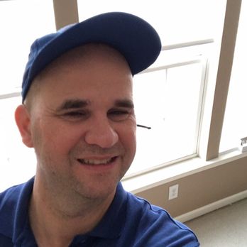 Elbaum's - a smiling man in a blue shirt and cap - Delis Near Me - Bayonne, New Jersey