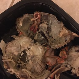 a close up of a crab in a container a close up of a crab in a container