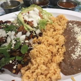 Cheese enchiladas with guajillo sauce topped with chorizo and potatoes and just a few of the fantastic salsas.