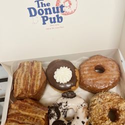 Two Maple Bacon Croissant Donuts, one Brooklyn Kreme, one Oreo, one Glazed Croissant Donut, and one Tres Leches Croissant Donut.