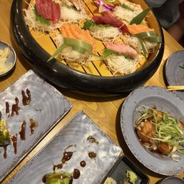 Sashimi, takoyaki and couple rolls Sashimi, takoyaki and couple rolls