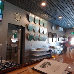 Forgottonia Brewing - Available beers on tap listed on the wall behind the bar counter.