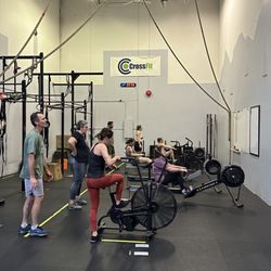 CrossFit - Group CrossFit class. A machine workout with hanging knee raises or toes to bar.