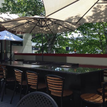 The Fireside Grill - Patio table with fire pit in center. - American Near Me - Beaverton, Oregon The Fireside Grill - Patio table with fire pit in center. - American Near Me - Beaverton, Oregon
