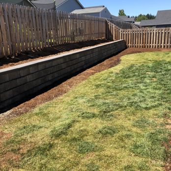 Gardner Landscape - a back yard with a retaining wall - Irrigation Near Me Gardner Landscape - a back yard with a retaining wall - Irrigation Near Me
