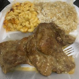 Smothered pork chops, rice with gravy and Mac & cheese