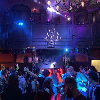 Endgame - Main DJ stage inside, with gaming areas around the sides of the dance floor. - Arcades Near Me - Mesa, Arizona