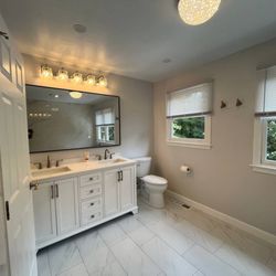 Sun Shore Construction - Bright and spacious bathroom with a sleek double vanity, modern lighting, and clean finishes. A refreshing upgrade! #BathroomRemodel