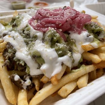 Taquiza - a plate of french fries with sauce - Tacos Near Me - Silverdale, Washington Taquiza - a plate of french fries with sauce - Tacos Near Me - Silverdale, Washington