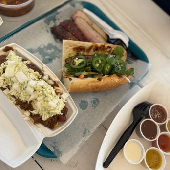 City Limits Barbeque - Slaw Dog with Brisket chili, Pork Belly Banh Mi - Barbeque Near Me - West Columbia, South Carolina City Limits Barbeque - Slaw Dog with Brisket chili, Pork Belly Banh Mi - Barbeque Near Me - West Columbia, South Carolina
