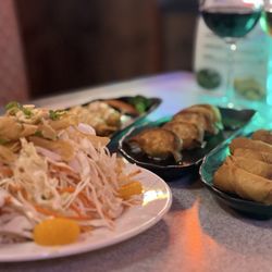 Columbia Eats Bar & Grill - Foreground: Asian salad From right: egg rolls, potstickers, fried shrimp