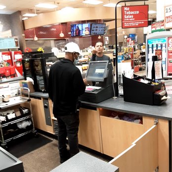 Wawa - a man standing at a cash register - Gas Stations Near Me - Orlando, Florida Wawa - a man standing at a cash register - Gas Stations Near Me - Orlando, Florida
