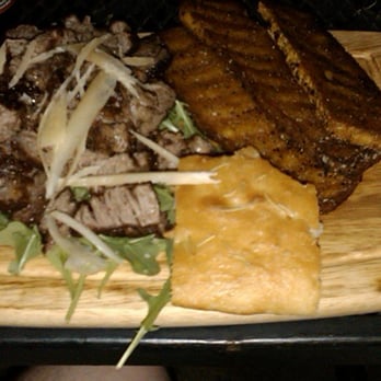 Nonna Tata - sirloin strips marinated in black truffle oil served over arugala & grated parmesan w/ fried polenta and rosemary specked bread - Italian Near Me - Fort Worth, Texas