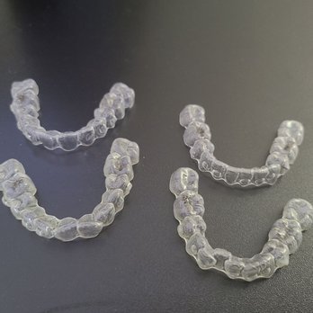 Brenn Orthodontics - Last set of aligners on top...first set on bottom. Huge difference! - Orthodontists Near Me - Burbank, California