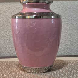 Pink is what my wife wanted. Up close, the urn is a work of art and solid metal. Pink is what my wife wanted. Up close, the urn is a work of art and solid metal.