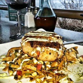 Rose's - Crabcake entree with vino and lake view in the background.. - Mediterranean Near Me - Grand Rapids, Michigan Rose's - Crabcake entree with vino and lake view in the background.. - Mediterranean Near Me - Grand Rapids, Michigan