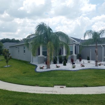 Huckleberry Landscaping - Grey decorative curbing with white marble rocks in the beds - Landscaping Near Me
