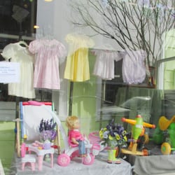 Bellies & Babies - Spring front window showing smocked dresses and some toys