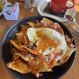 Chilaquiles with over-easy eggs and gooey cheese