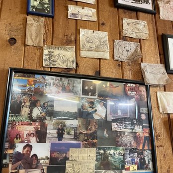 Cafe Rio - a collage of photos and postcards on a wall - Pizza Near Me - Ruidoso, New Mexico