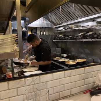 Carmelina's - The chef hard at work. Loved sitting at the bar and seeing all the food prepared - Italian Near Me - Boston, Massachusetts