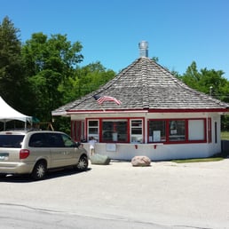 a small white building with a red roof