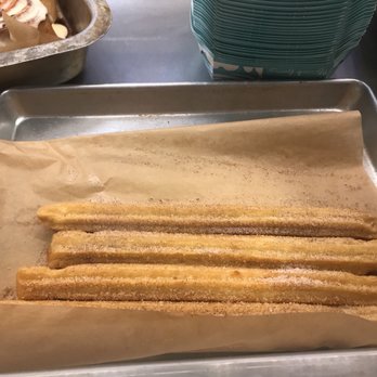 Cinnabon - a pan of churrons on a table - Bakeries Near Me - Philadelphia, Pennsylvania