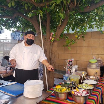 Marios Tacos - a man in a face mask preparing food - Mexican Near Me - Bloomington, California