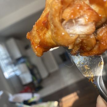 Buffalo Wild Wings - a hand holding a fork full of buffalo wings - Chicken Wings Near Me - Riverdale, Utah Buffalo Wild Wings - a hand holding a fork full of buffalo wings - Chicken Wings Near Me - Riverdale, Utah