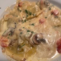 Portabella mushroom ravioli in Alfredo sauce with tomatoes Portabella mushroom ravioli in Alfredo sauce with tomatoes