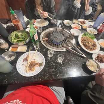 Pine Tree Korean BBQ Restaurant - Drinks, salad, sides, and first round of meats done. Japchae on the big plate - Korean Near Me - Northridge, California